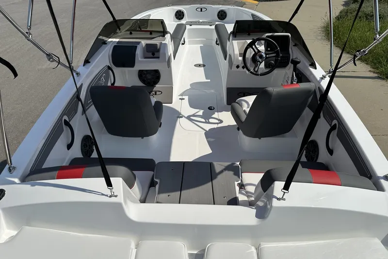Slide: The Image of Interior view of a 2027 Tahoe T21 boat, featuring modern seating and steering wheel. - 25