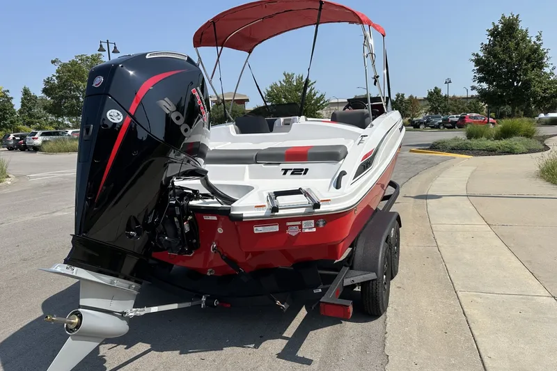 Slide: The Image of Red and white 2027 Tahoe T21 boat with a powerful outboard motor on a trailer. - 4