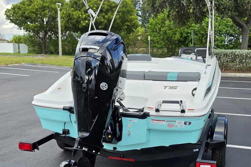 Slide: The Image of 2027 Tahoe T16 boat with outboard motor in a parking lot. - 8