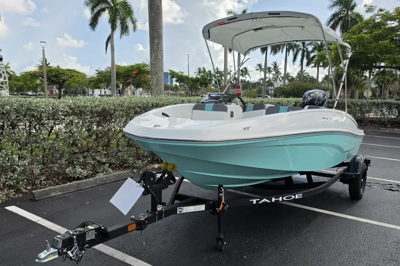 Slide: The Image of 2027 Tahoe T16 boat on trailer in parking lot, surrounded by palm trees. - 3