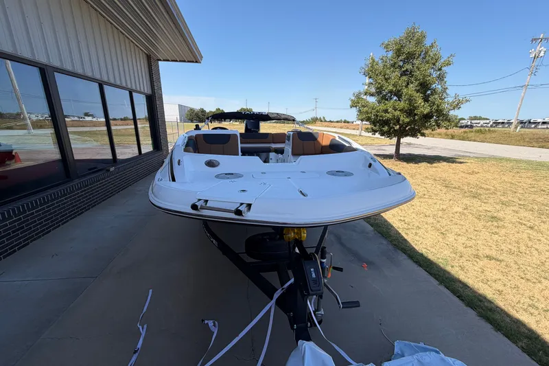 Slide: The Image of 2027 Tahoe 1950 boat on trailer, parked outdoors near a building. - 15
