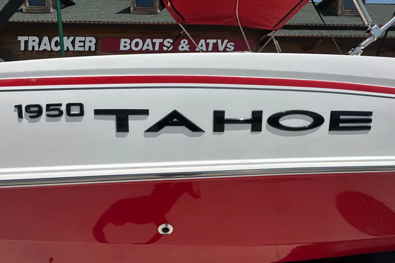 Slide: The Image of 2027 Tahoe 1950 boat with red and white design at Tracker Boats & ATVs store. - 2