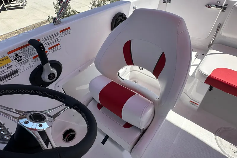 Slide: The Image of Captain's seat and steering wheel of a 2027 Tahoe 1950 boat, featuring red and white upholstery. - 20
