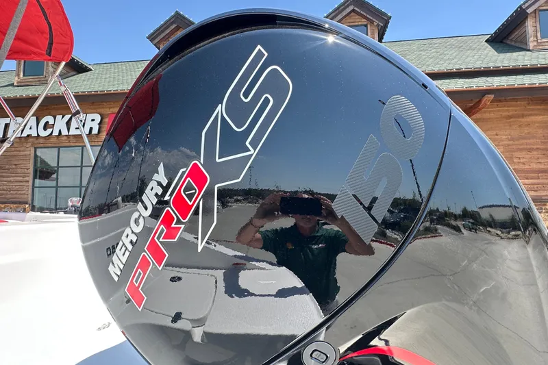Slide: The Image of Mercury Pro XS 150 engine on Tahoe 1950, 2027 model, outside Tracker store. - 9