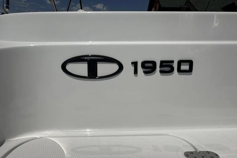 Slide: The Image of 2027 Tahoe 1950 model logo on white surface, showcasing sleek design. - 8