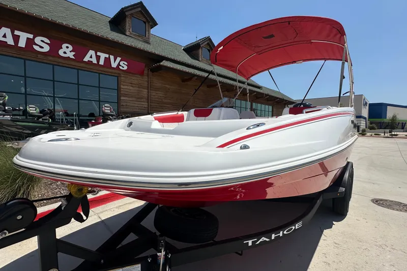 Slide: The Image of 2027 Tahoe 1950 boat with red canopy displayed outside dealership. - 3