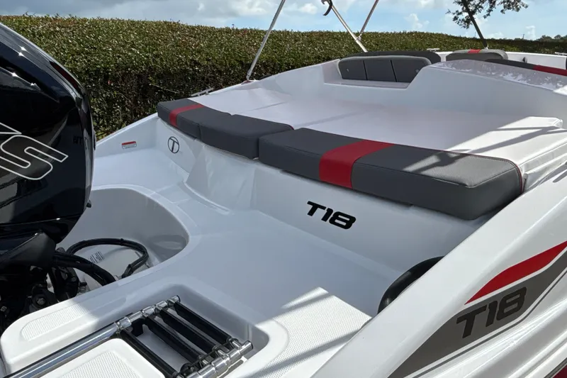 Slide: The Image of 2027 Tahoe T18 boat with cushioned seating and outboard motor, showcasing sleek design. - 8
