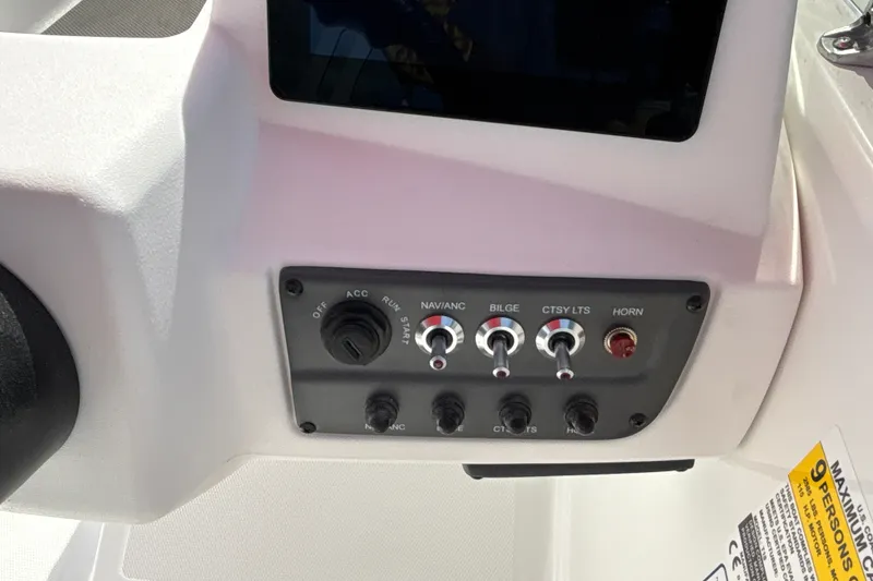Slide: The Image of Control panel of 2027 Tahoe T18 boat with switches for navigation, bilge, lights, and horn. - 14