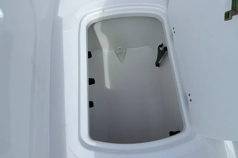Slide: The Image of Open storage compartment in 2027 Tahoe T18 boat. - 21