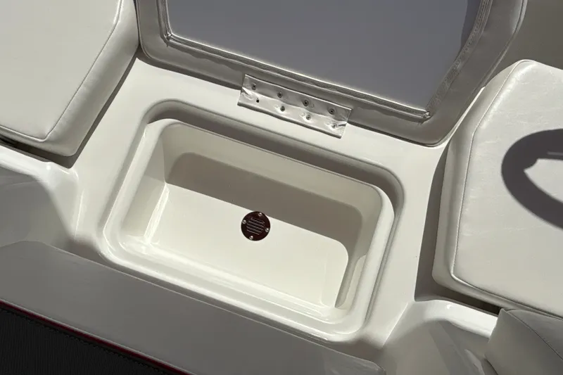 Slide: The Image of 2027 Tahoe T18 boat interior storage compartment with cushioned seating. - 24
