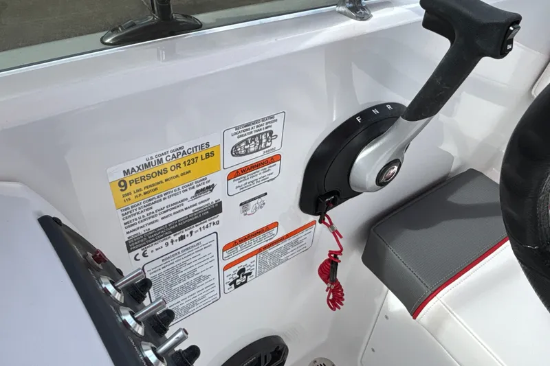Slide: The Image of Control panel of 2027 Tahoe T18 boat with capacity and safety warnings. - 17