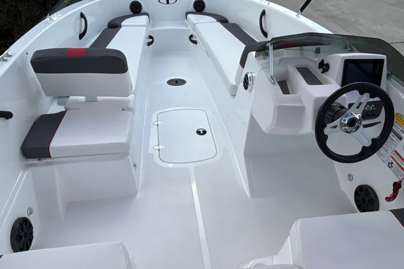 Slide: The Image of 2027 Tahoe T18 boat interior with sleek seating and modern steering console. - 10