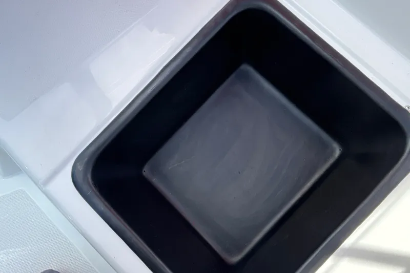 Slide: The Image of Black square compartment in 2027 Tahoe T18 boat interior. - 22