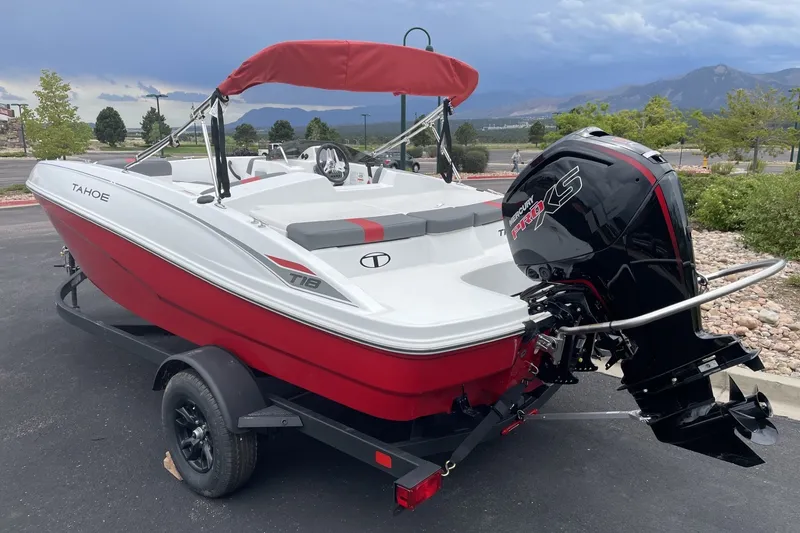 Slide: The Image of Red and white 2027 Tahoe T18 boat with Mercury Pro XS engine on trailer. - 2