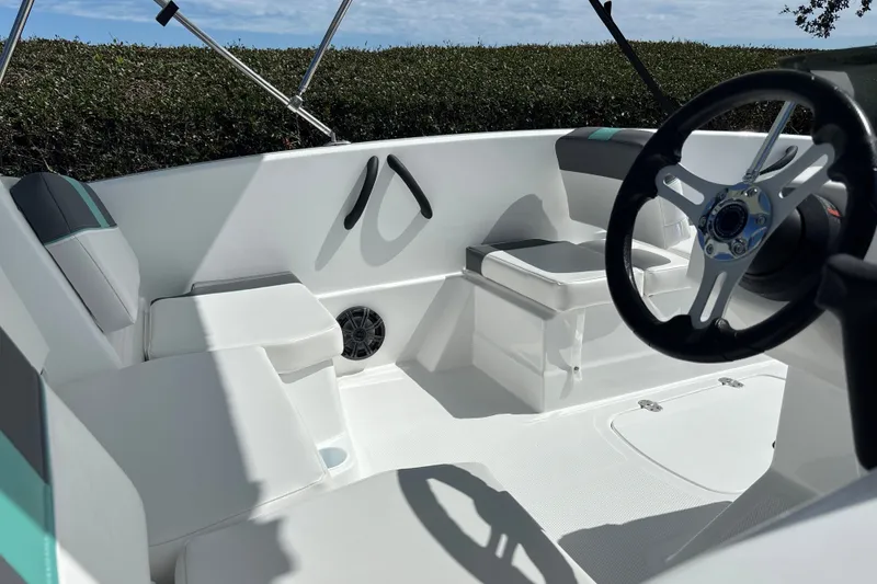 Slide: The Image of Interior of a 2027 Tahoe T16 boat featuring sleek seating and modern steering wheel. - 16