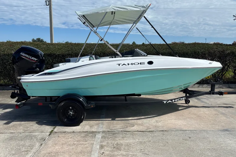 Slide: The Image of 2027 Tahoe T16 boat with canopy on trailer, featuring a Mercury engine. - 3