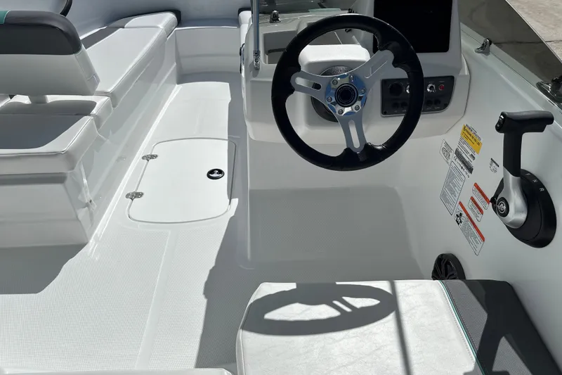 Slide: The Image of Interior of 2027 Tahoe T16 boat featuring steering wheel and seating area. - 8