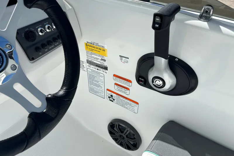Slide: The Image of Control panel of a 2027 Tahoe T16 boat with steering wheel and throttle lever. - 14
