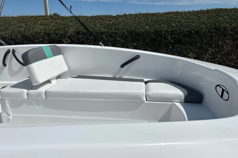 Slide: The Image of 2027 Tahoe T16 boat interior with white and teal seating, sleek design. - 17