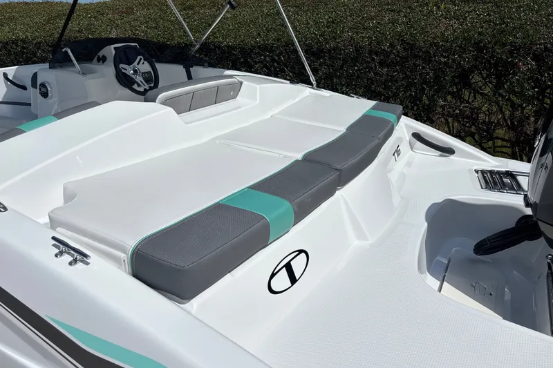 Slide: The Image of 2027 Tahoe T16 boat interior with sleek seating and modern steering console. - 19