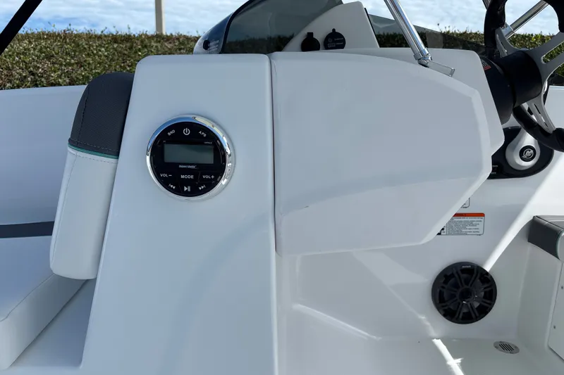Slide: The Image of 2027 Tahoe T16 boat dashboard with audio controls and steering wheel. - 12