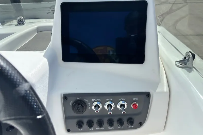 Slide: The Image of Dashboard of a 2027 Tahoe T16 boat with touchscreen and control switches. - 11