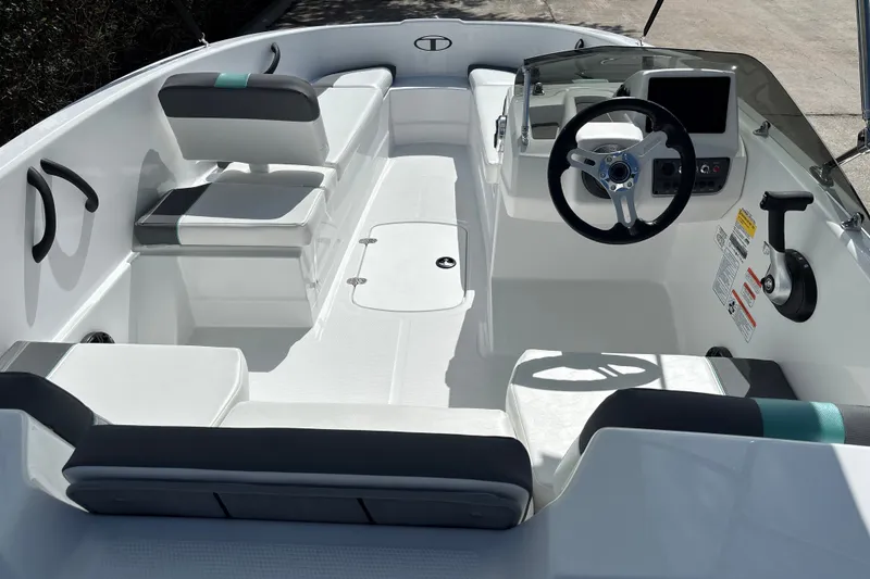 Slide: The Image of Interior view of a 2027 Tahoe T16 boat, featuring modern seating and steering console. - 7
