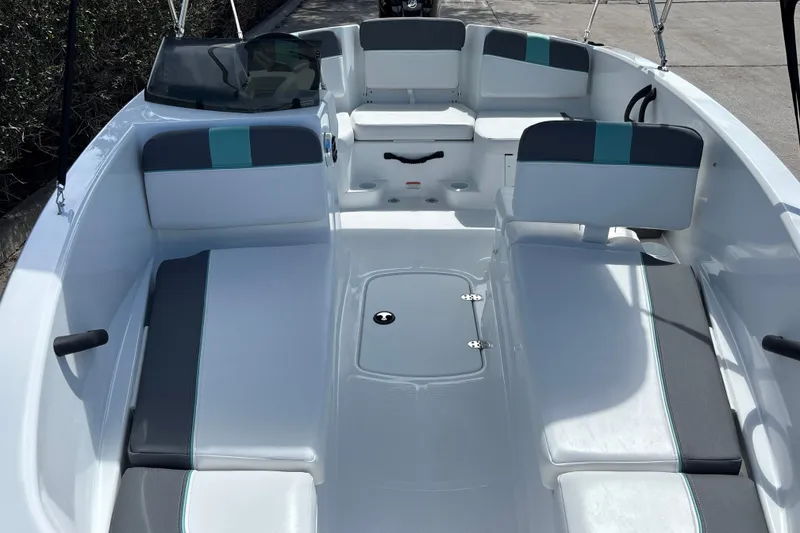 Slide: The Image of 2027 Tahoe T16 boat interior with gray and teal seating, spacious layout, and modern design. - 20