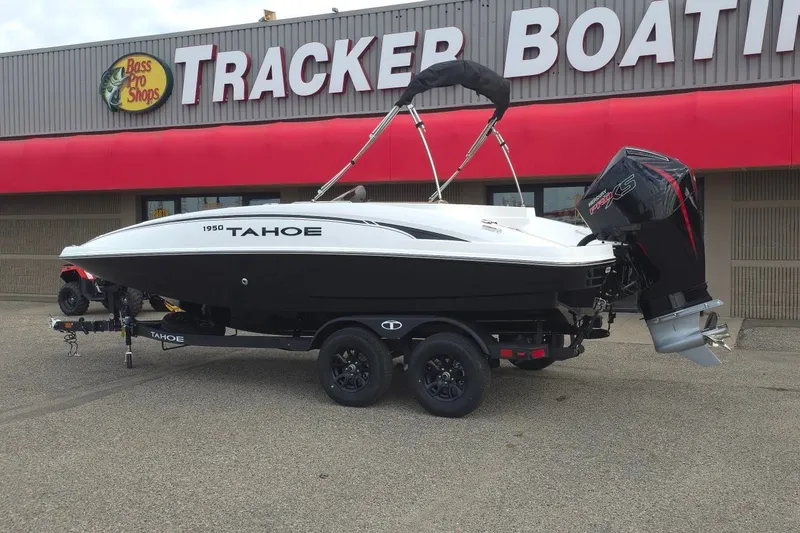 Slide: The Image of 2027 Tahoe 1950 boat on trailer outside Tracker Boating Center. - 2