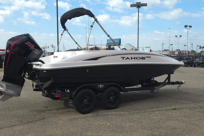 Slide: The Image of 2027 Tahoe 1950 boat on trailer, featuring sleek design and powerful engine, parked outdoors. - 3