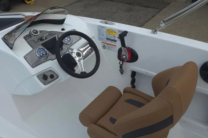 Slide: The Image of Steering console of a 2027 Tahoe 1950 boat with brown seating and modern controls. - 8