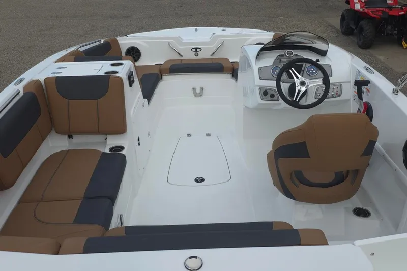 Slide: The Image of 2027 Tahoe 1950 boat interior with brown and black seating, modern steering console. - 7
