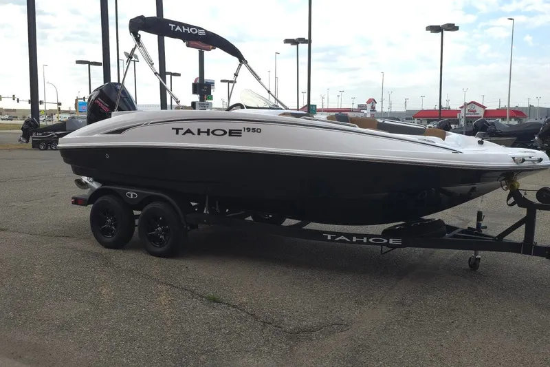 Slide: The Image of 2027 Tahoe 1950 boat on trailer in parking lot, side view. - 5