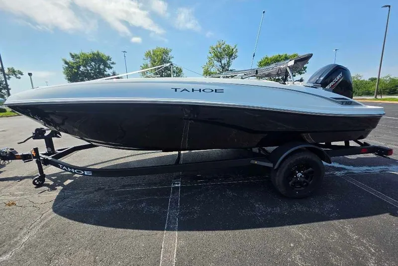The Image of 2027 Tahoe T18 boat on trailer in parking lot, sunny day. - 0