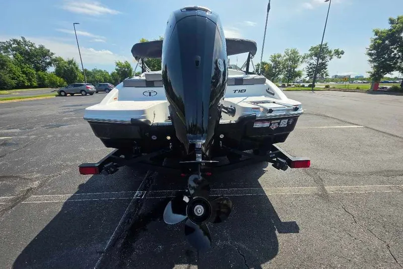 Slide: The Image of 2027 Tahoe T18 boat on trailer, rear view in parking lot. - 4