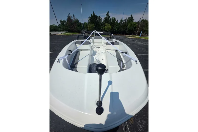Slide: The Image of 2027 Tahoe T18 boat in parking lot, showcasing sleek design and spacious interior. - 8