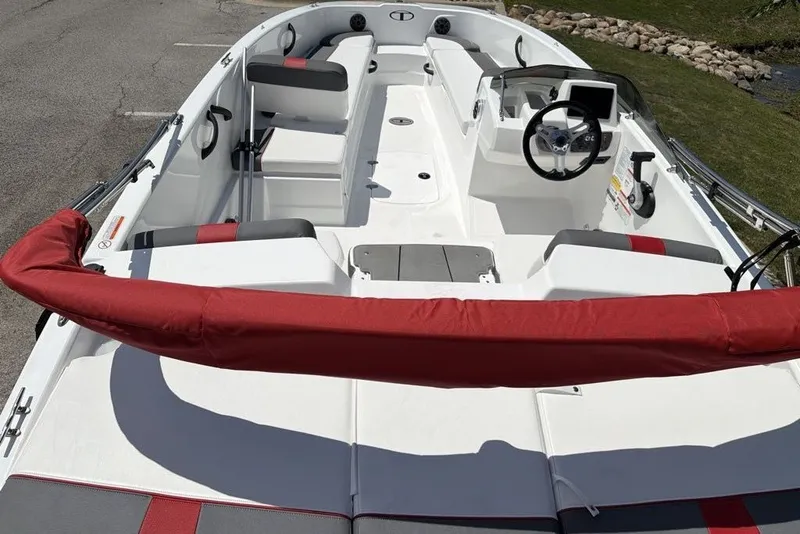 Slide: The Image of 2027 Tahoe T18 boat interior with red and gray seating, steering wheel, and console. - 8