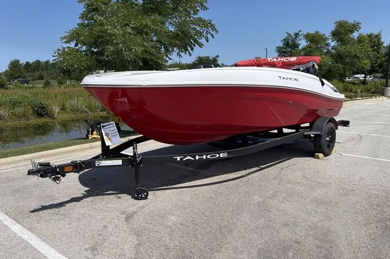 Slide: The Image of Red 2027 Tahoe T18 boat on trailer in sunny parking lot. - 1