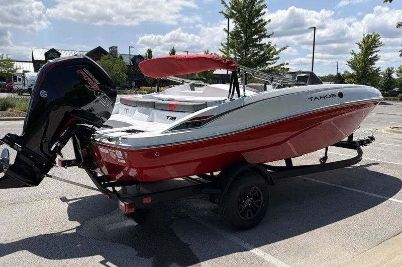 Slide: The Image of 2027 Tahoe T18 boat with red hull and outboard motor in parking lot. - 3