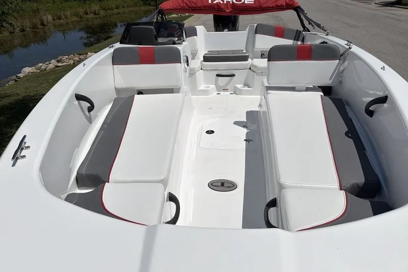 Slide: The Image of 2027 Tahoe T18 boat interior with white and gray seating, red accents, and spacious layout. - 6