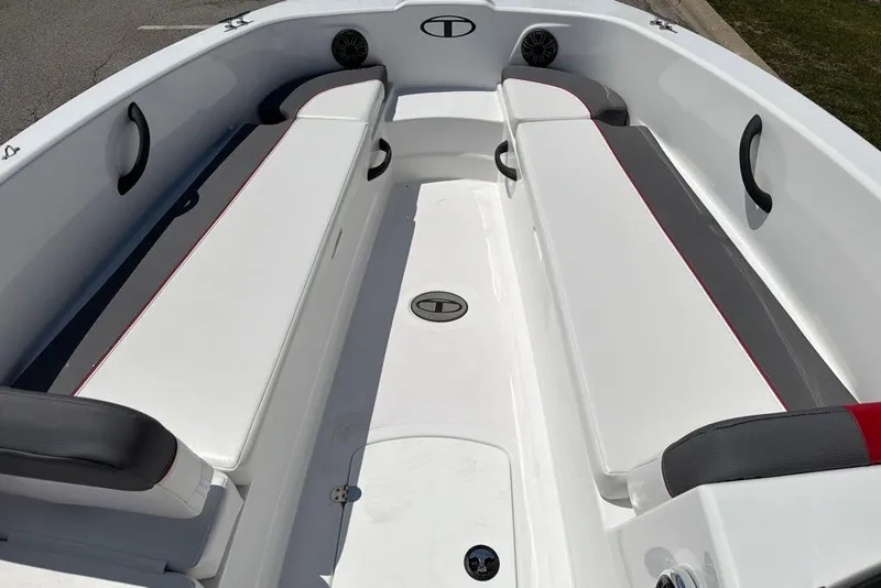 Slide: The Image of 2027 Tahoe T18 boat interior with white and gray seating, red accents, and cup holders. - 9