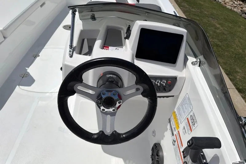 Slide: The Image of Steering console of 2027 Tahoe T18 boat with modern controls and display screen. - 10
