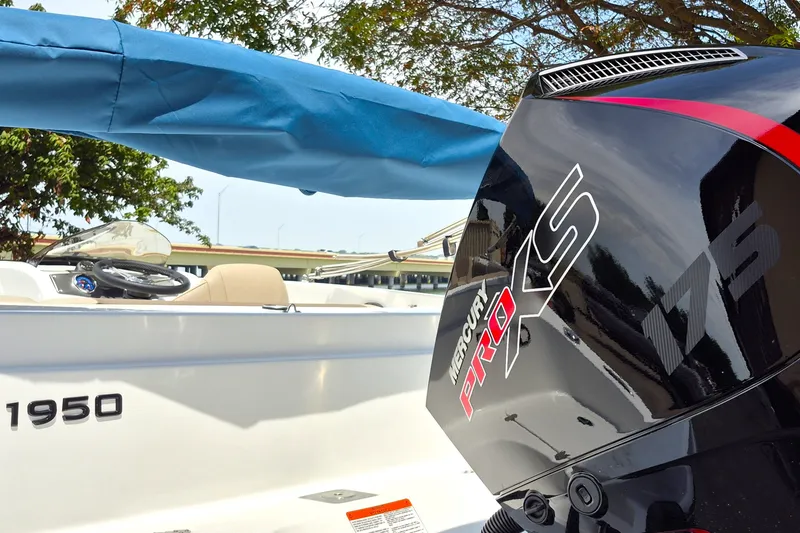 Slide: The Image of 2027 Tahoe 1950 boat with Mercury Pro XS 175 engine, under blue cover. - 8