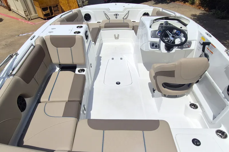 Slide: The Image of 2027 Tahoe 1950 boat interior with beige seating and modern dashboard. - 9