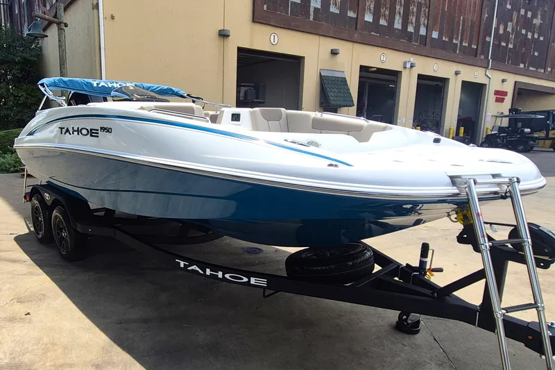 Slide: The Image of 2027 Tahoe 1950 boat on trailer outside a building. - 3