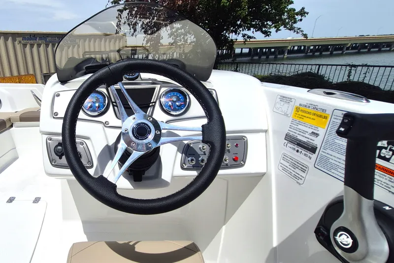 Slide: The Image of Steering console of 2027 Tahoe 1950 boat with gauges and controls, near waterfront. - 10