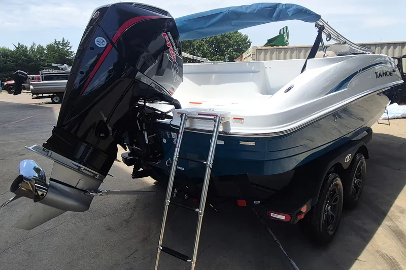 Slide: The Image of 2027 Tahoe 1950 boat with powerful outboard motor and ladder, parked on a trailer. - 5