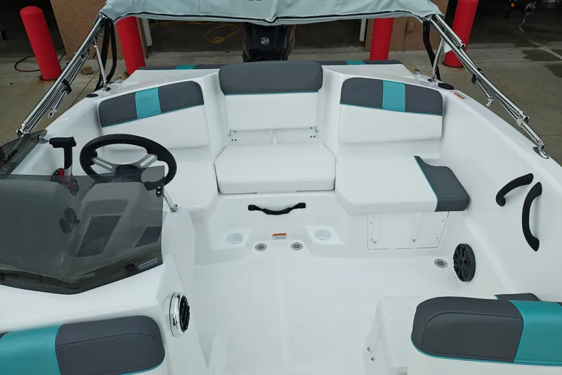 Slide: The Image of 2027 Tahoe T16 boat interior with modern seating and steering wheel, featuring teal accents. - 9