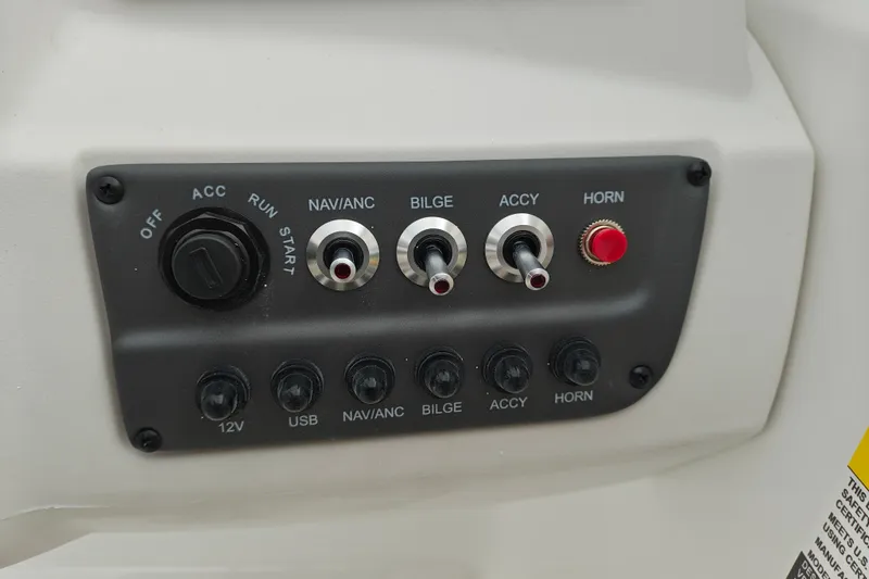 Slide: The Image of Control panel of a 2027 Tahoe T16 boat with switches and ignition. - 12
