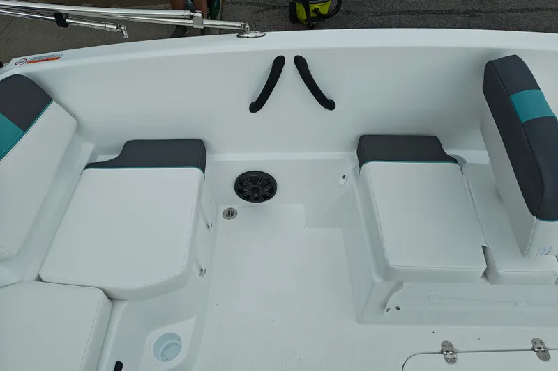Slide: The Image of Interior of a 2027 Tahoe T16 boat featuring cushioned seating and a speaker. - 15